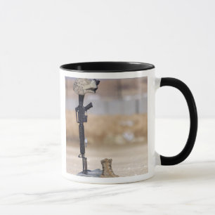 Boots, rifle, dog tags, and protective helmet mug