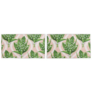 Bouquet of lilly of the valley flowers on green pillowcase