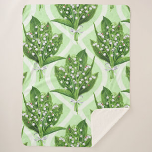 Bouquet of lilly of the valley flowers on green sherpa blanket