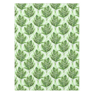 Bouquet of lilly of the valley flowers on green tablecloth