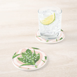 Bouquet of lilly of the valley flowers on pink coaster