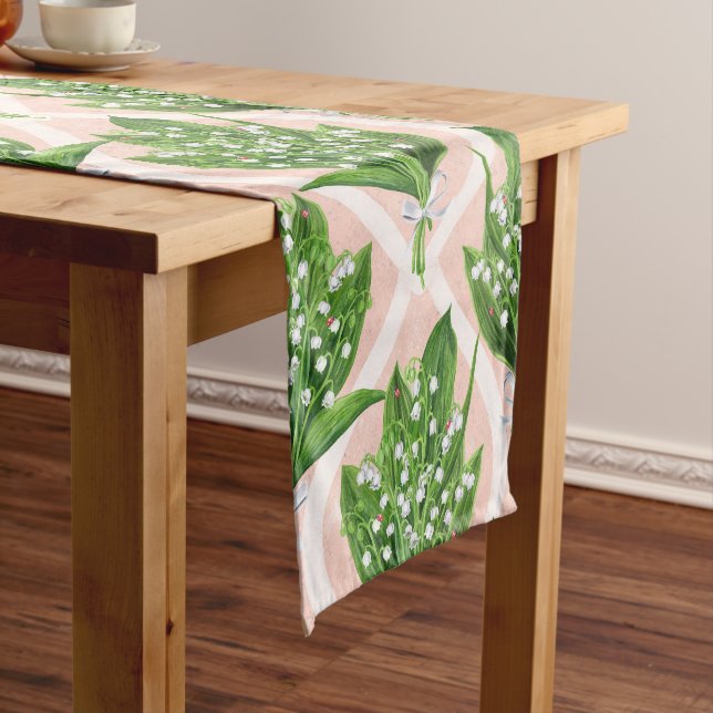 Bouquet of lilly of the valley flowers on pink short table runner (In Situ)