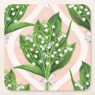Bouquet of lilly of the valley flowers on pink square paper coaster