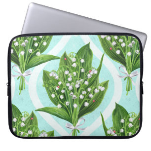 Bouquet of lily of the valley flowers on blue laptop sleeve