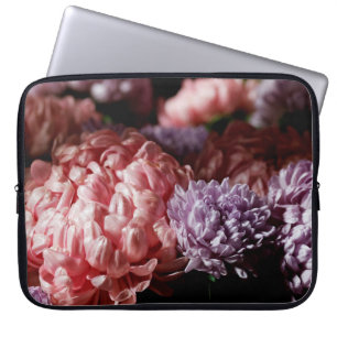 Bouquet of pink with purple aster flowers in light laptop sleeve