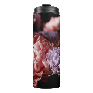 Bouquet of pink with purple aster flowers in light thermal tumbler