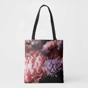Bouquet of pink with purple aster flowers in light tote bag