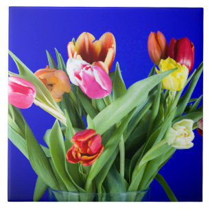 Bouquet of tulips on blue ceramic tile