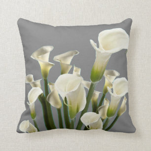 BOUQUET OF WHITE CALLA LILIES ON GREY CUSHION