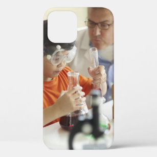 Boy (6-7) and teacher in chemistry class iPhone 12 case