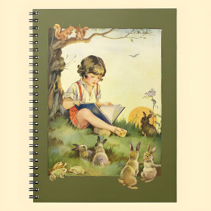 Boy reading under tree with rabbits notebook