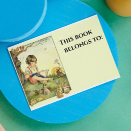 Boy reading under tree with rabbits rectangular sticker