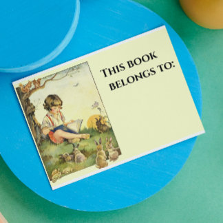 Boy reading under tree with rabbits rectangular sticker