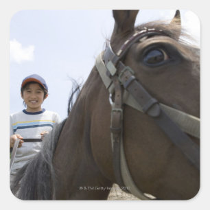 Boy riding a horse square sticker