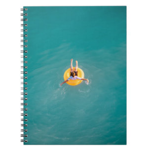 Boy sitting on buoy notebook