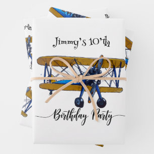 Boys birthday party with blue and yellow biplane wrapping paper sheet