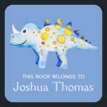 Boys Blue This Book Belongs Dinosaur and Name Kids Square Sticker<br><div class="desc">This beautiful boy's 'this book belongs' bookplate design features a watercolor blue and gold dinosaur,  and has place for you to add your kids name in lovely typography. Perfect for your child's back to school supplies. Check out the rest of our collection for other cute kids items.</div>
