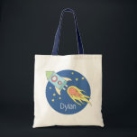 Boys Colourful Rocket Ship Space Galaxy and Name Tote Bag<br><div class="desc">This gorgeous kids tote bag features a beautiful and colourful hand drawn rocket ship in outer space. The design also features a place for you to add your boys name. Perfect for any toddler or child,  or for a new mum to use as a diaper bag!</div>