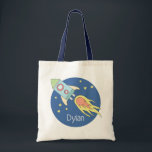 Boys Colourful Rocket Ship Space Galaxy and Name Tote Bag<br><div class="desc">This gorgeous kids tote bag features a beautiful and colourful hand drawn rocket ship in outer space. The design also features a place for you to add your boys name. Perfect for any toddler or child,  or for a new mum to use as a diaper bag!</div>