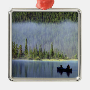Boys fishing from canoe with mist in metal ornament