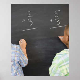 Boys solving math problems on blackboard poster