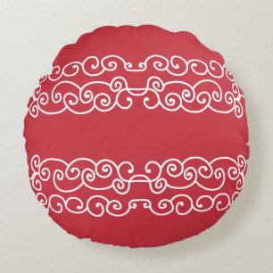 Brick red with white scrolls round cushion