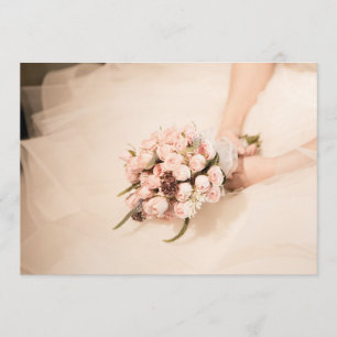 Bride holding pink rose bouquet on wedding invite