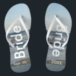 Bride Ocean Waves Beach Sand Thongs<br><div class="desc">Pretty Blue Sky with Light Fluffy White Clouds, Blue Sea, Crashing Ocean Waves and Beach Sand. Unisex Flip Flops with Bride and Date of Marriage written in a white text. PERSONALIZE with your Wedding DATE (or delete text). The wedding date is written in the sand. Choose wide or slim straps...</div>