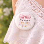 Bride to be ivory pink  bow pearls Bachelorette 6 Cm Round Badge<br><div class="desc">Celebrate your special milestone with this chic bachelorette party button. The design features a luxurious pink bow adorned with delicate pearl strands and sophisticated gold-toned script. It serves as a stylish accessory for the bride-to-be to wear during her bridal shower or night out with bridesmaids. Ivory background color.</div>