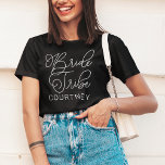 Bride Tribe White Modern Script Custom Wedding T-Shirt<br><div class="desc">Modern and casual chic white calligraphy script "Bride Tribe" women's wedding tee shirt features custom text that can be personalised for your bridal party crew. Perfect for your bridesmaids to wear at the bachelorette party and the wedding weekend!</div>