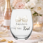 Bride tying the knot ivory bow Bachelorette Stemless Wine Glass<br><div class="desc">Celebrate in style with this elegant bachelorette party shot glass. The design features a delicate ivory,  cream colored bow accented with pearls. It makes a perfect commemorative gift for the bride-to-be to use during her bridal shower or girls' night out.</div>