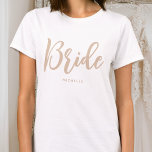 Bride Wedding Personalised Name Beige White T-Shirt<br><div class="desc">Celebrate the bride-to-be with a unique custom t-shirt! A simple and stylish design featuring trendy script lettering,  and personalised with the bride's name,  wedding date,  location or other text. This stylish beige and white t-shirt,  makes a lovely gift for a bachelorette party,  wedding shower or celebration weekend!</div>