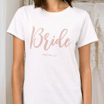 Bride Wedding Personalised Name Dusty Pink White T-Shirt<br><div class="desc">Celebrate the bride-to-be with a unique custom t-shirt! A simple and stylish design featuring trendy script lettering,  and personalised with the bride's name,  wedding date,  location or other text. This stylish dusty pink and white t-shirt,  makes a lovely gift for a bachelorette party,  wedding shower or celebration weekend!</div>