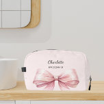 Bridesmaid bow pink elegant name dopp kit<br><div class="desc">A soft blush pink background. Decorated with a large pink bow.
Personalise and add your bridesmaid's name.</div>