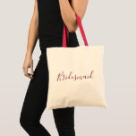 Bridesmaid Burgundy font Tote Bag<br><div class="desc">A beautiful tote bag for a beautiful bridesmaid,  this design features "Bridesmaid" written in lovely cursive burgundy font.  Place your order today!</div>