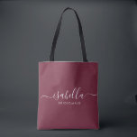 Bridesmaid Gift Burgundy Personalised Tote Bag<br><div class="desc">This Bridesmaid accessory bag features a handwritten white script typography with swashes on a burgundy background. Present your bridesmaids with a tote bag for small items traditionally presented at the rehearsal dinner,  for use in the early morning before the wedding.</div>
