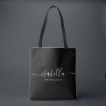 Bridesmaid Gift Personalised Black Tote Bag<br><div class="desc">This Bridesmaid accessory bag features a handwritten white script typography with swashes on a black background. Present your bridesmaids with a tote bag for small items traditionally presented at the rehearsal dinner,  for use in the early morning before the wedding.</div>