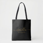 Bridesmaid Gift Personalised Gold Script Black Tote Bag<br><div class="desc">This Bridesmaid accessory bag features a handwritten gold script typography with swashes on a black background. Present your bridesmaids with a tote bag for small items traditionally presented at the rehearsal dinner,  for use in the early morning before the wedding.</div>