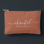 Bridesmaid Modern Script Cosmetic Terracotta Accessory Pouch<br><div class="desc">This Bridesmaid accessory bag features a handwritten white script typography with swashes on a terracotta background. Present your bridesmaids with a toiletry bag for their makeup and small items traditionally presented at the rehearsal dinner,  for use in the early morning before the wedding.</div>