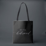 Bridesmaid's Gift Wedding Party Modern Minimalist Tote Bag<br><div class="desc">Elevate the art of gifting with our Personalised Bridesmaid Tote Bag – a timeless expression of appreciation and a symbol of cherished moments. Crafted with simplicity and elegance, this tote bag boasts modern romantic calligraphy that spells out "Bridesmaid" in exquisite white script, tailored to perfection. Black and white converge in...</div>