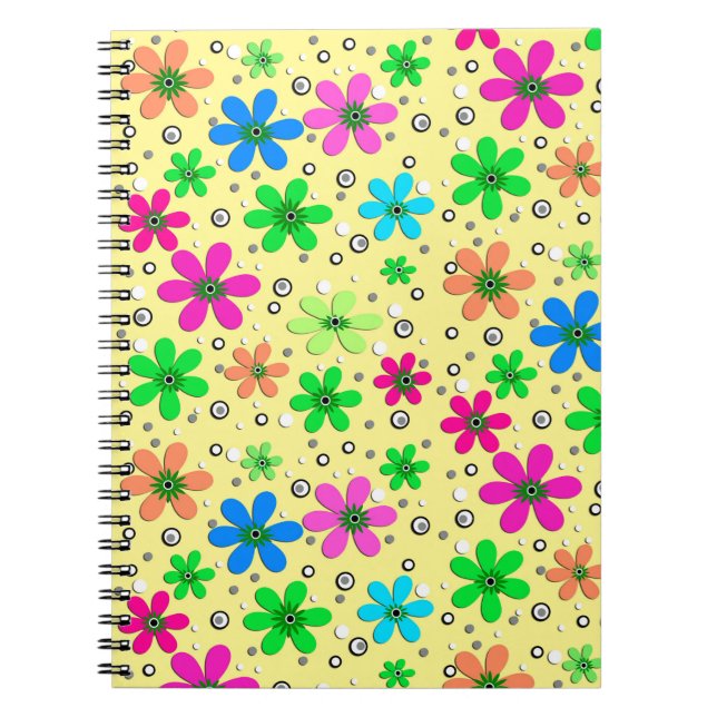 Bright multi-coloured chamomile flowers on a yello notebook (Front)