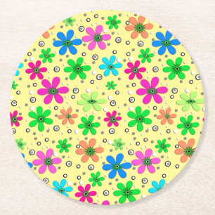 Bright multi-coloured chamomile flowers on a yello round paper coaster
