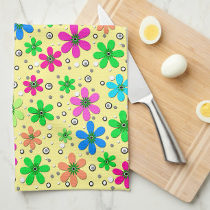 Bright multi-coloured chamomile flowers on a yello tea towel