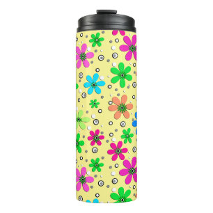 Bright multi-coloured chamomile flowers on a yello thermal tumbler