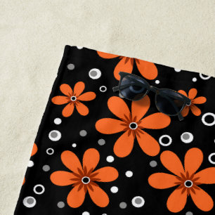 Bright orange flowers on a black background with w beach towel