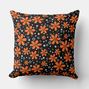 Bright orange flowers on a black background with w cushion