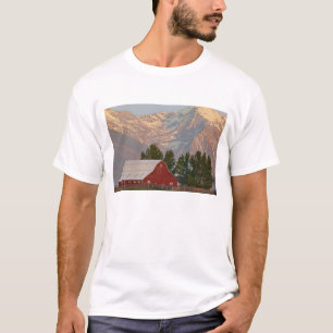 Bright red barn against Mission Mountains in T-Shirt