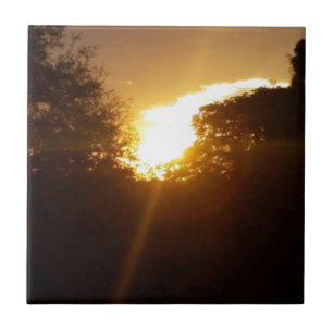 Brilliant sunrise over the trees ceramic tile