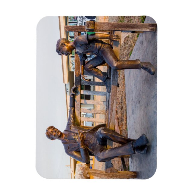 Bronze statue of young and older talking magnet (Vertical)