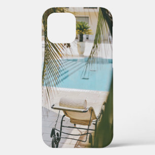 Brown and black armchair beside swimming pool in t iPhone 12 case
